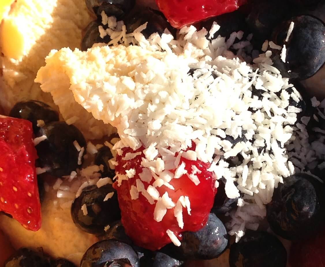 Raw Dairy Ice Cream with Blueberries Strawberries and Coconut Flakes